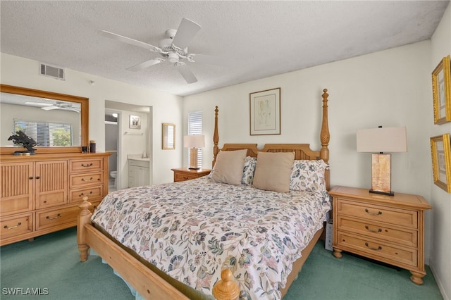 9900 Sunset Cove Ln Unit 111, Fort Myers, FL 33919 - carpeted bedroom with a textured ceiling, ensuite bath, and a ceiling fan