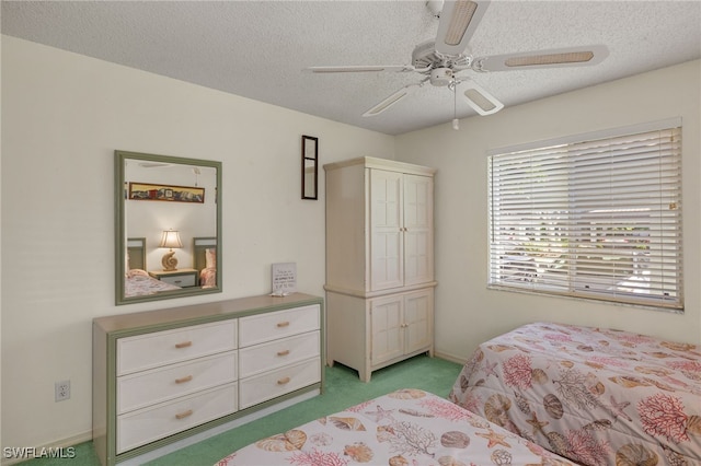 9900 Sunset Cove Ln Unit 111, Fort Myers, FL 33919 - bedroom with light carpet, a textured ceiling, a ceiling fan, and baseboards
