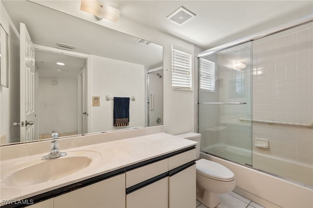 9900 Sunset Cove Ln Unit 111, Fort Myers, FL 33919 - bathroom with tile patterned floors, toilet, vanity, and enclosed tub / shower combo