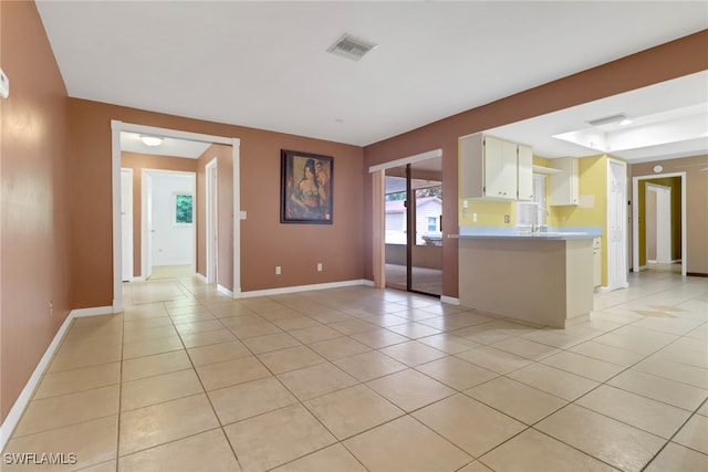 spare room with light tile patterned floors and baseboards