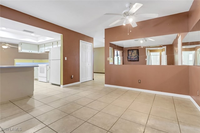 unfurnished living room with ceiling fan, light tile patterned floors, and baseboards