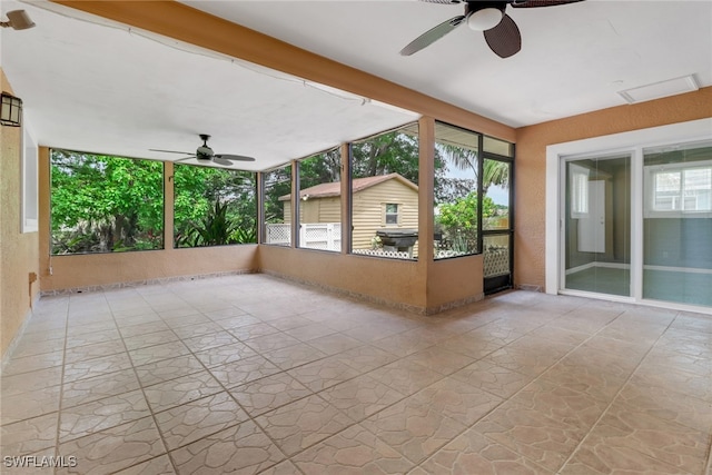 unfurnished sunroom featuring a ceiling fan