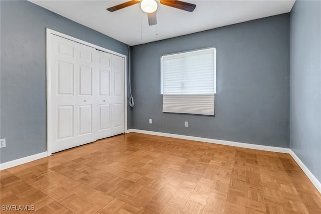 unfurnished bedroom with baseboards, a closet, and a ceiling fan