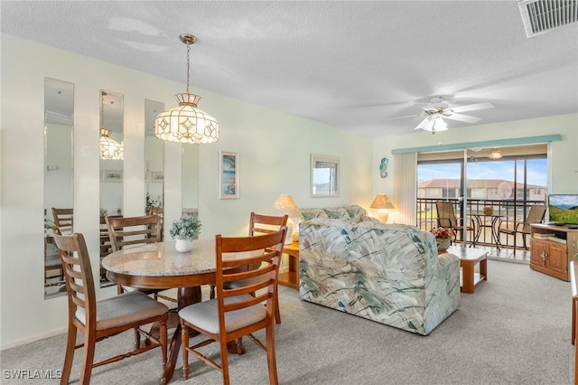 25100 Sandhill Blvd Unit R202, Punta Gorda, FL 33983 - dining area with a textured ceiling, a ceiling fan, and light colored carpet