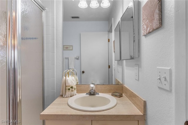 25100 Sandhill Blvd Unit R202, Punta Gorda, FL 33983 - bathroom with vanity, an enclosed shower, and a textured wall