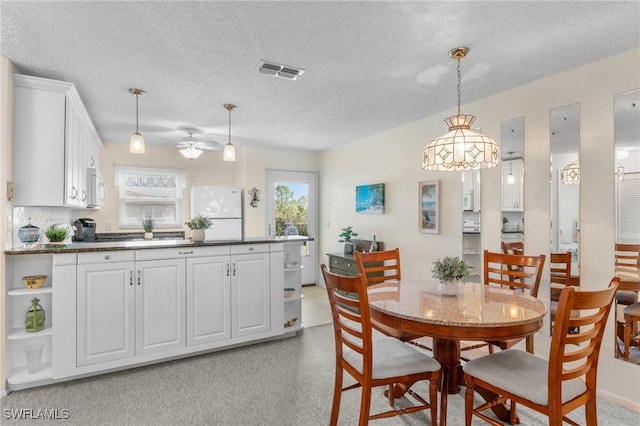 25100 Sandhill Blvd Unit R202, Punta Gorda, FL 33983 - dining area featuring a textured ceiling and ceiling fan