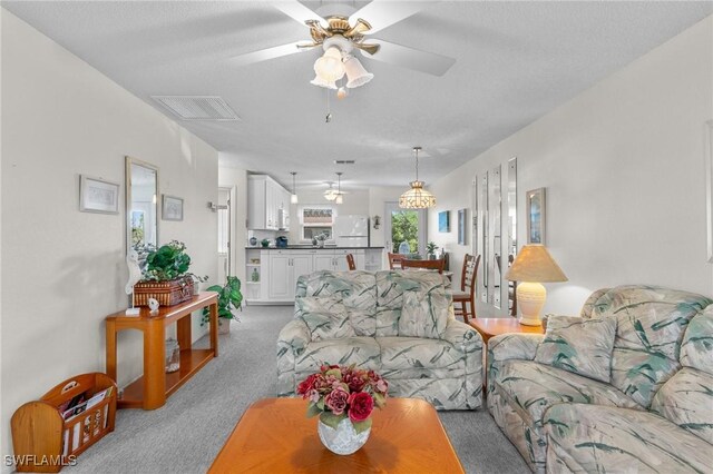 25100 Sandhill Blvd Unit R202, Punta Gorda, FL 33983 - living room with ceiling fan and light colored carpet