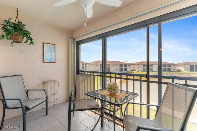 25100 Sandhill Blvd Unit R202, Punta Gorda, FL 33983 - sunroom with a textured wall, plenty of natural light, a residential view, and a ceiling fan