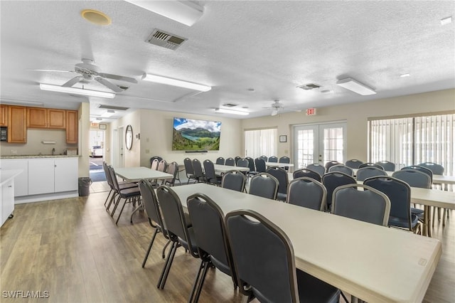 25100 Sandhill Blvd Unit R202, Punta Gorda, FL 33983 - dining room with ceiling fan, a textured ceiling, and light wood-style flooring