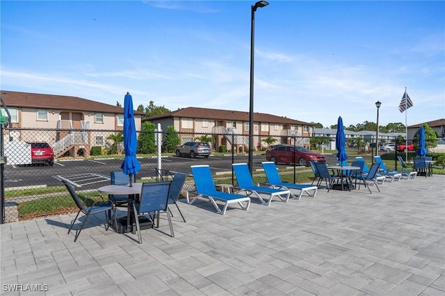 25100 Sandhill Blvd Unit R202, Punta Gorda, FL 33983 - view of patio / terrace featuring fence, a residential view, and outdoor dining area