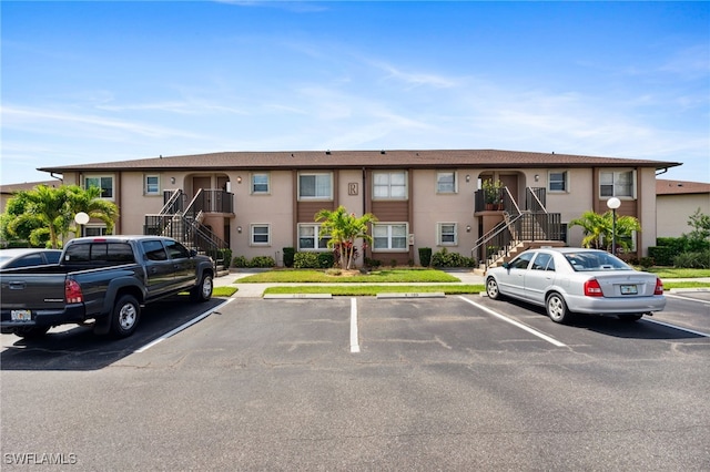 25100 Sandhill Blvd Unit 201, Punta Gorda, FL 33983 - view of property with stairway and uncovered parking