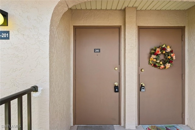 25100 Sandhill Blvd Unit 201, Punta Gorda, FL 33983 - view of exterior entry featuring stucco siding
