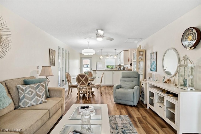 25100 Sandhill Blvd Unit 201, Punta Gorda, FL 33983 - living room featuring wood finished floors and a ceiling fan