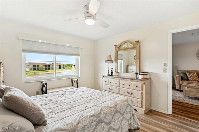 25100 Sandhill Blvd Unit 201, Punta Gorda, FL 33983 - bedroom featuring light wood finished floors, a ceiling fan, and baseboards