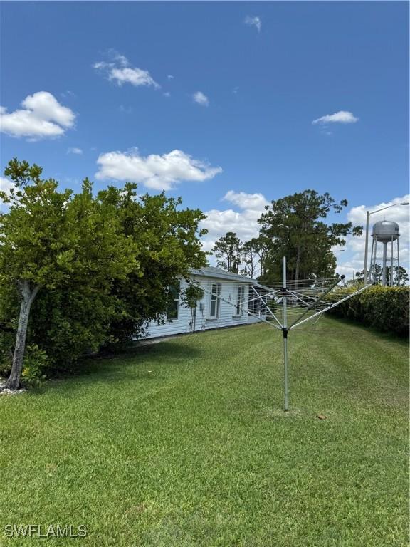 5 Desert Candle Cir, Lehigh Acres, FL 33936 - view of green lawn