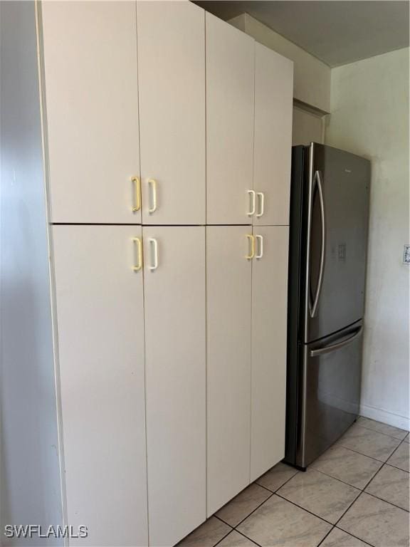 5 Desert Candle Cir, Lehigh Acres, FL 33936 - kitchen with freestanding refrigerator, white cabinetry, and light tile patterned floors