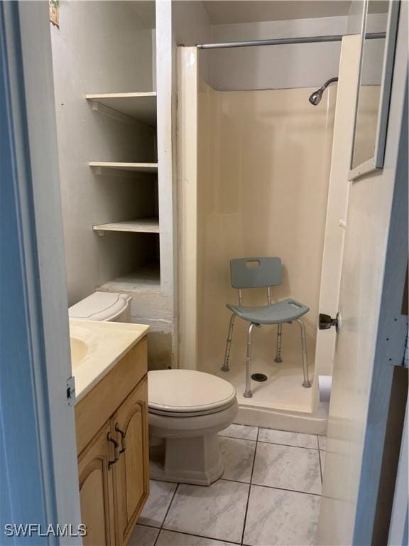 5 Desert Candle Cir, Lehigh Acres, FL 33936 - full bath with a shower stall, toilet, vanity, and tile patterned flooring