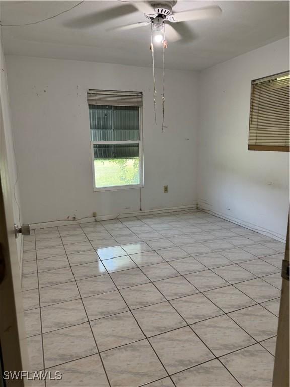 5 Desert Candle Cir, Lehigh Acres, FL 33936 - empty room with ceiling fan, light tile patterned floors, and baseboards