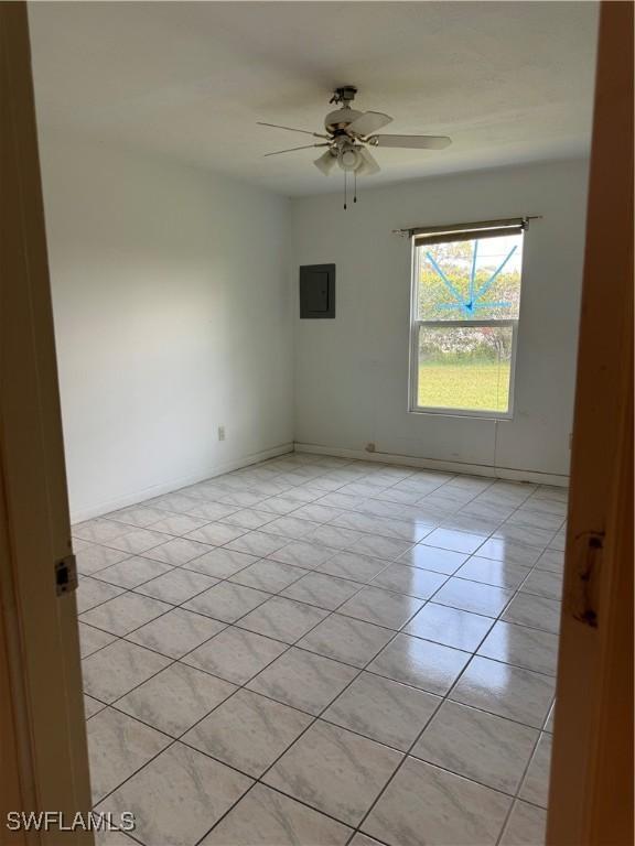 5 Desert Candle Cir, Lehigh Acres, FL 33936 - unfurnished room with a ceiling fan, light tile patterned floors, and baseboards