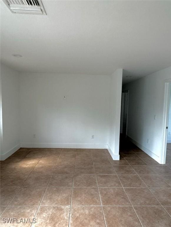 803 Monroe Dr, Lehigh Acres, FL 33936 - empty room with tile patterned flooring and baseboards