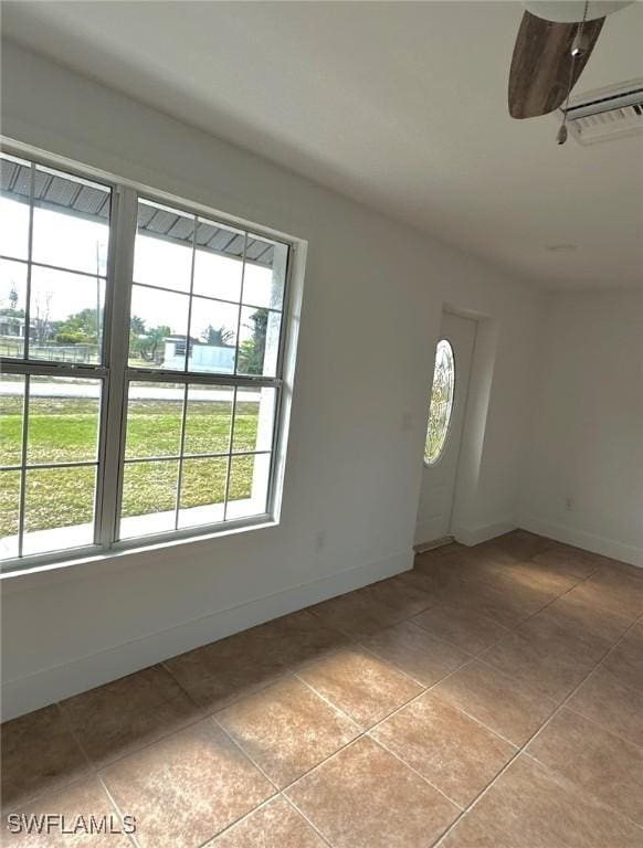 803 Monroe Dr, Lehigh Acres, FL 33936 - foyer entrance featuring light tile patterned flooring and baseboards
