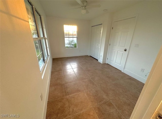 803 Monroe Dr, Lehigh Acres, FL 33936 - spare room featuring tile patterned flooring, a ceiling fan, and baseboards