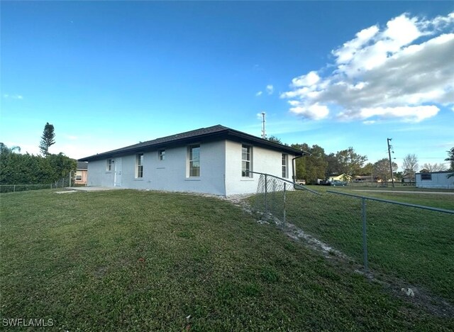 803 Monroe Dr, Lehigh Acres, FL 33936 - view of property exterior with stucco siding
