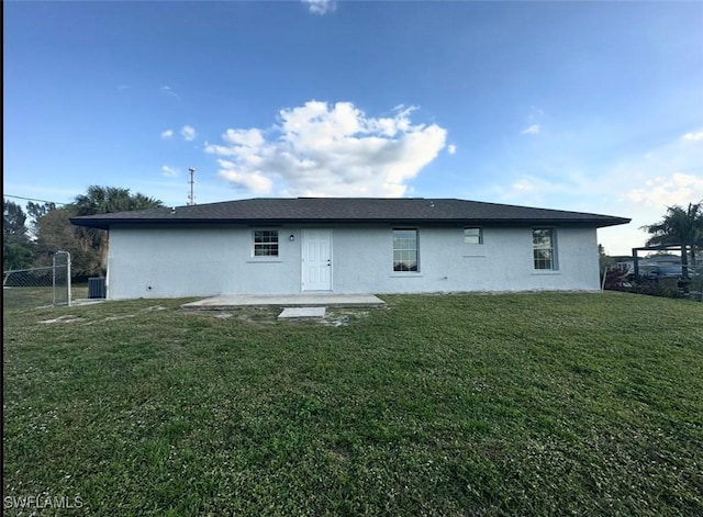 803 Monroe Dr, Lehigh Acres, FL 33936 - rear view of property featuring stucco siding