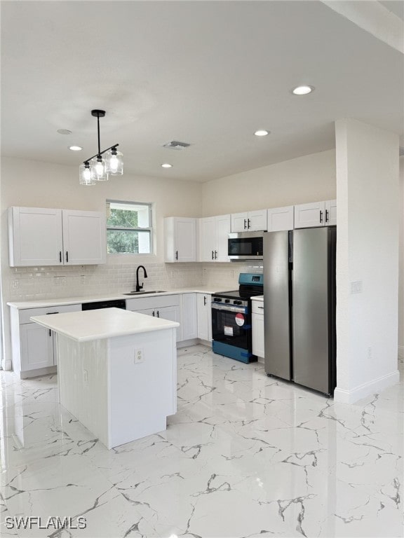16 W 7th St, Lehigh Acres, FL 33972 - kitchen with stainless steel appliances, a sink, recessed lighting, backsplash, and light countertops