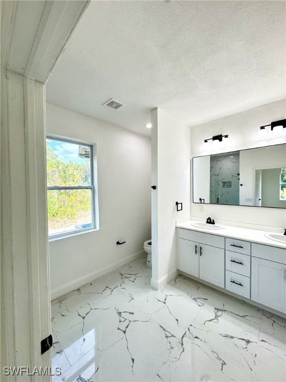 16 W 7th St, Lehigh Acres, FL 33972 - bathroom featuring baseboards, marble finish flooring, toilet, double vanity, and a shower