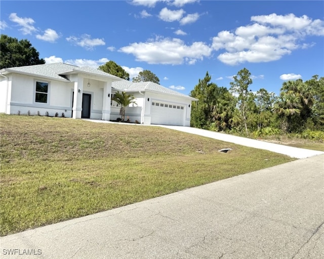 16 W 7th St, Lehigh Acres, FL 33972 - view of front of house with stucco siding, a garage, concrete driveway, and a front lawn