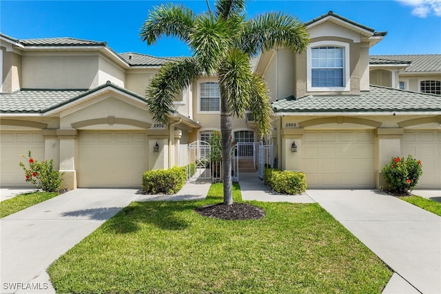 14521 Grande Cay Cir Unit 2902, Fort Myers, FL 33908 - townhome / multi-family property featuring concrete driveway, stucco siding, a tile roof, and a garage