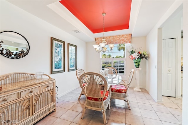 14521 Grande Cay Cir Unit 2902, Fort Myers, FL 33908 - dining area featuring a chandelier, a raised ceiling, light tile patterned flooring, and baseboards