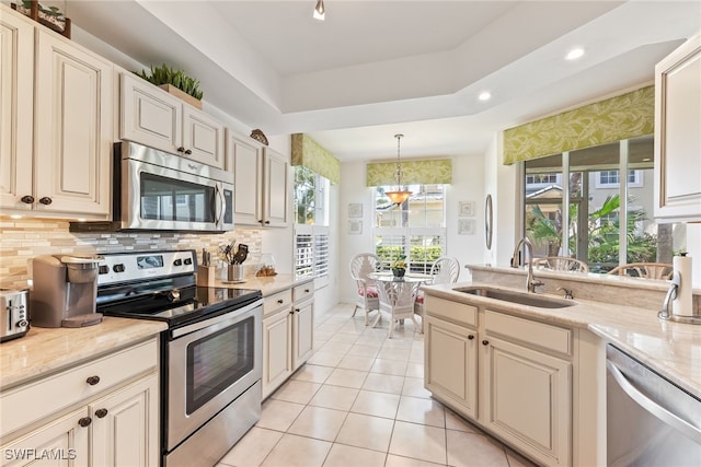 14521 Grande Cay Cir Unit 2902, Fort Myers, FL 33908 - kitchen with appliances with stainless steel finishes, a sink, decorative backsplash, light tile patterned floors, and recessed lighting