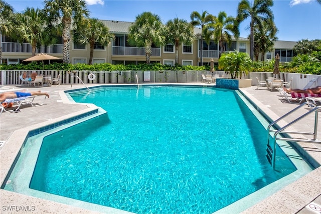 14521 Grande Cay Cir Unit 2902, Fort Myers, FL 33908 - community pool with a patio area and fence
