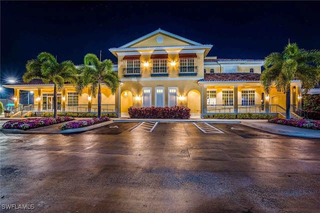 14521 Grande Cay Cir Unit 2902, Fort Myers, FL 33908 - view of front of house with stucco siding, uncovered parking, covered porch, and a tiled roof