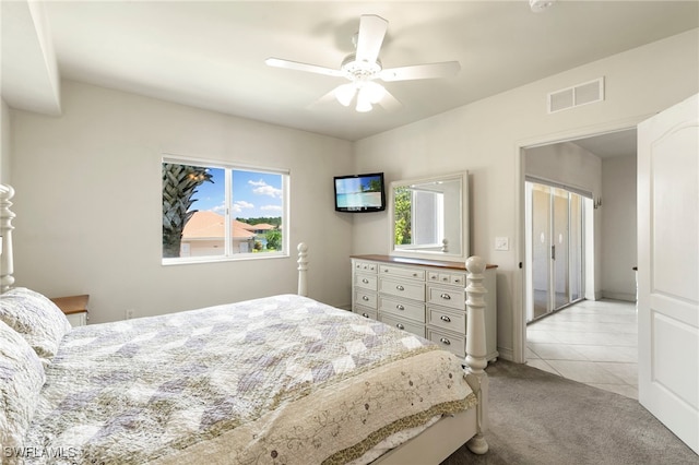 7839 Regal Heron Cir Unit 205, Naples, FL 34104 - bedroom with multiple windows, light tile patterned floors, light carpet, and a ceiling fan