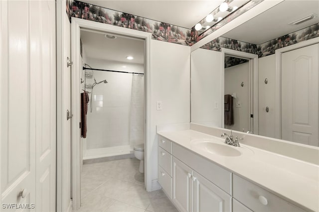 7839 Regal Heron Cir Unit 205, Naples, FL 34104 - full bathroom featuring toilet, tile patterned flooring, vanity, and a tile shower