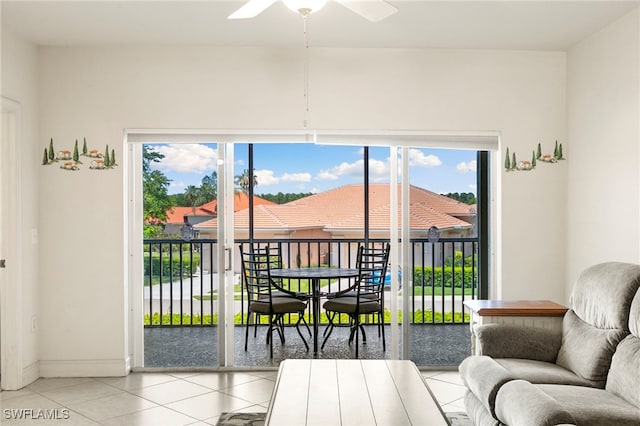 7839 Regal Heron Cir Unit 205, Naples, FL 34104 - living area with light tile patterned floors, a ceiling fan, healthy amount of natural light, and baseboards