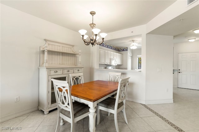 7839 Regal Heron Cir Unit 205, Naples, FL 34104 - dining area with a chandelier, baseboards, light tile patterned floors, and a ceiling fan