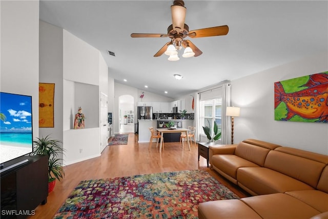 12839 Oakpointe Cir, Fort Myers, FL 33912 - living room with vaulted ceiling, ceiling fan, light wood-style floors, arched walkways, and baseboards