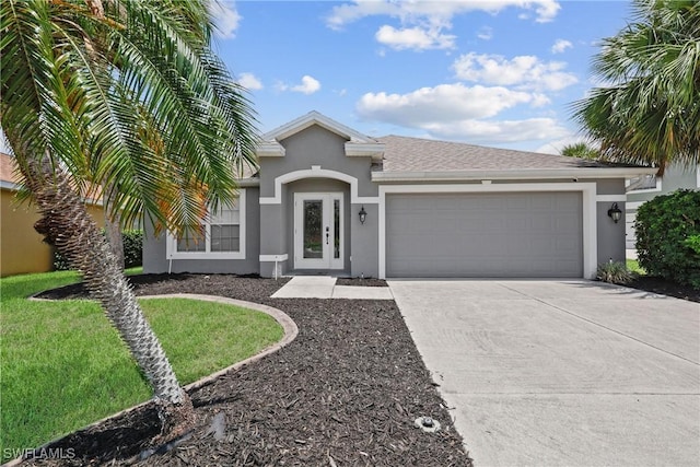 12839 Oakpointe Cir, Fort Myers, FL 33912 - view of front of property featuring stucco siding, concrete driveway, a garage, and a front yard