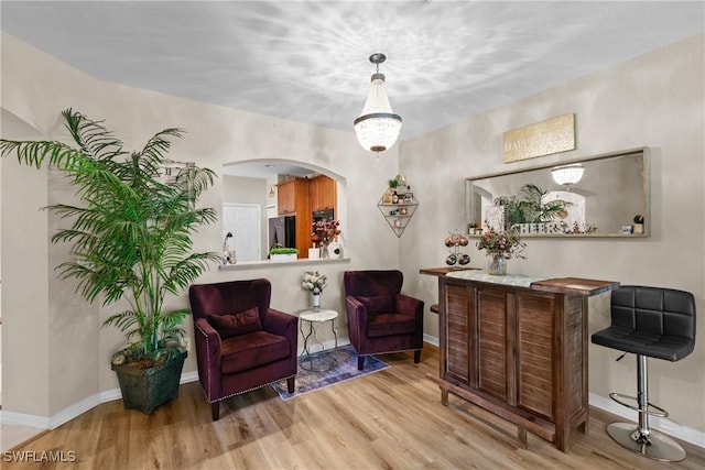 17504 Cherry Ridge Ln, Fort Myers, FL 33967 - living area with wood finished floors, arched walkways, and baseboards