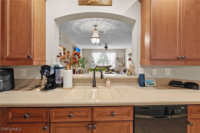 17504 Cherry Ridge Ln, Fort Myers, FL 33967 - kitchen featuring black dishwasher, a sink, arched walkways, light countertops, and brown cabinetry