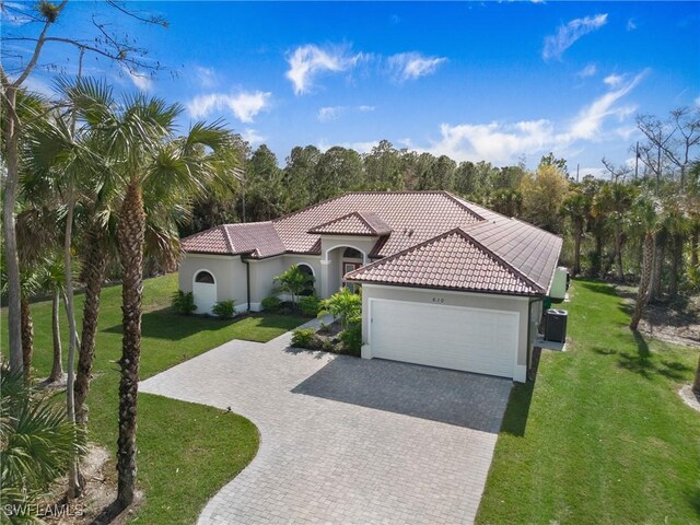 610 25th Ave NW, Naples, FL 34120 - mediterranean / spanish-style house featuring a garage, stucco siding, and a front lawn