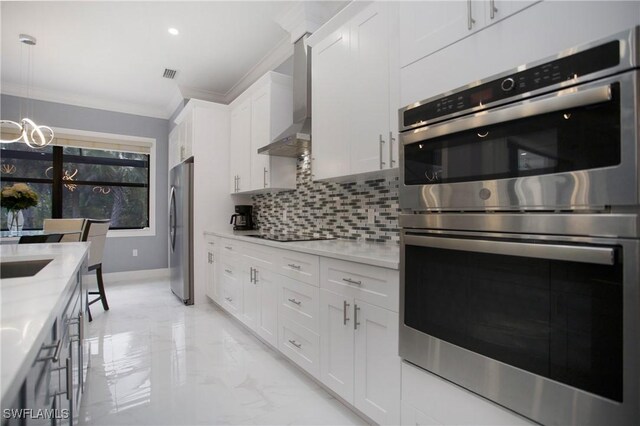 610 25th Ave NW, Naples, FL 34120 - kitchen with stainless steel appliances, ornamental molding, light marble finish floors, decorative backsplash, and wall chimney range hood