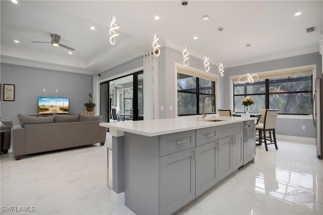 610 25th Ave NW, Naples, FL 34120 - kitchen featuring a sink, gray cabinets, light marble finish floors, a ceiling fan, and light countertops