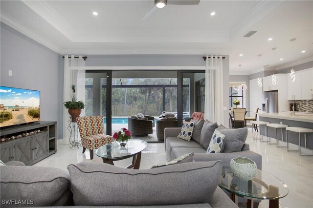 610 25th Ave NW, Naples, FL 34120 - living room featuring light marble finish floors, a tray ceiling, crown molding, ceiling fan, and recessed lighting