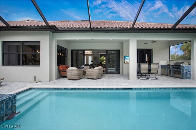 610 25th Ave NW, Naples, FL 34120 - back of house featuring exterior kitchen, stucco siding, ceiling fan, a patio, and an outdoor pool