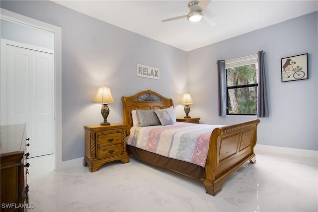 610 25th Ave NW, Naples, FL 34120 - bedroom featuring marble look tile flooring, a ceiling fan, and baseboards